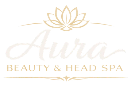 Aura Beauty & Head Spa — a gold lotus above the studio's script wordmark